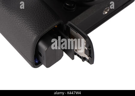 Closeup of battery and sdxc storage memory card in a camera opened slot, isolated on white. Stock Photo