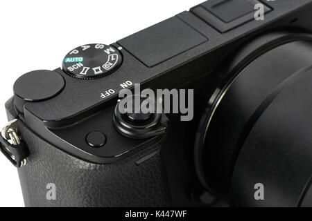 Closeup of mode selection dial and shutter release button on a Mirrorless Camera, isolated on white. Stock Photo