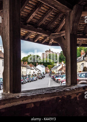 View through the Yarn market down the High Street towards the castle in Dunster near Minehead, Somerset. Stock Photo
