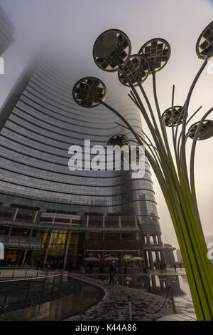 Milan, Lombardy, Italy. Gae Aulenti Square with iconic streetlights. Stock Photo