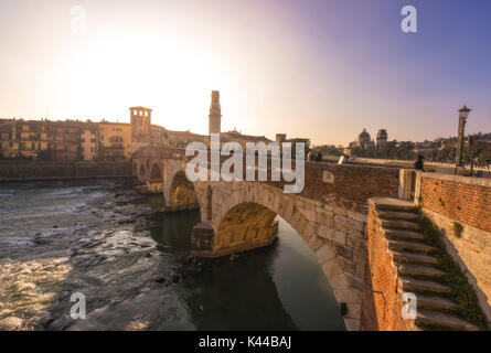 Verona, Veneto, Italy. Ponte Pietra bridge during a sunset. Stock Photo