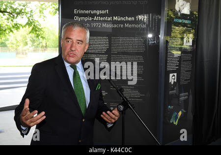Munich, Germany. 4th Sep, 2017. Ludwig Spaenle, Minister of Education in Bavaria (CSU), explains an information board at the memorial site for the 1972 Munich massacre of the Israeli Olympic team in Munich, Germany, 4 September 2017. The memorial site at the western Linden hill remembers the victims of the Palestinian attackers that killed eleven members of the Israeli Olympic team during the Summer Olympics 1972 in Munich, the capital of Bavaria. Photo: Felix Hörhager/dpa/Alamy Live News Stock Photo