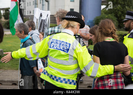 London, UK. 4th Sep, 2017. Police officers usher campaigners against the arms trade and the supply of arms to Israel out of the road after they blocked the entry of a truck carrying military equipment into the ExCel Centre for the DSEI arms fair. Credit: Mark Kerrison/Alamy Live News