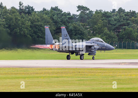 A USAF F-15E Strike Eagle from the 494th Fighter Squadron applies reheat as it takes off from RAF Lakenheath in Suffolk on a training sortie. Stock Photo