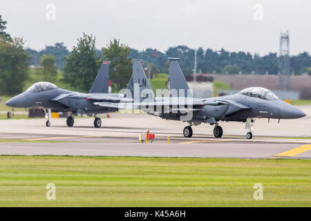 A pair of F-15E Stike Eagles (from the 48th Fighter Wing) taxi onto the runway at RAF Lakenheath to begin a training sortie above the skies of the UK. Stock Photo