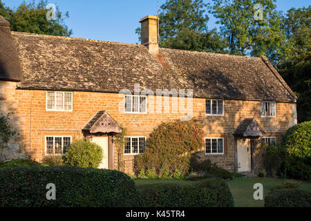 Morning sunlight on cottages in the cotswold village of Great Tew, Oxfordshire, England Stock Photo