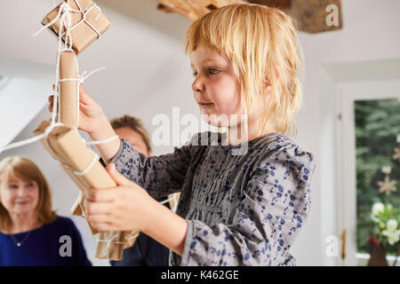 Grandmother, mother and little daughter with advent calendar, Stock Photo