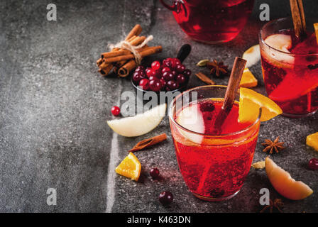 Fall and winter cold drinks, cranberry and orange holiday christmas punch with cinnamon, anise stars,  on black background copy space Stock Photo