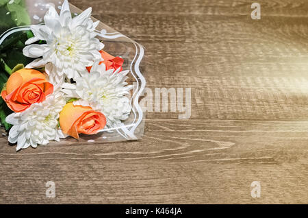 Bouquet of flowers lying on a wooden background Stock Photo