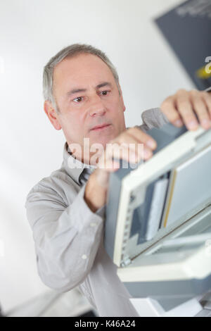 businessman hold ink cartridge to put into printer Stock Photo