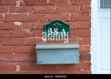 vintage mailbox and number on brick wall Stock Photo