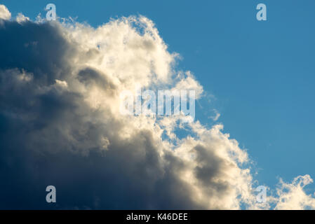 Dramatic sky background with dark black clouds and blue sky, before the storm Stock Photo