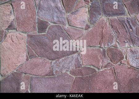 walls of rough red stone in different sizes and shapes Stock Photo