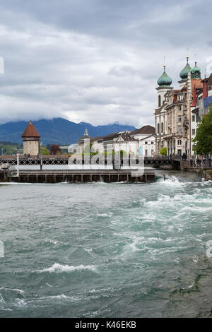 Cityscape of Lucerne city in central Switzerland, Reuss river with Chapel Bridge on horizon Stock Photo