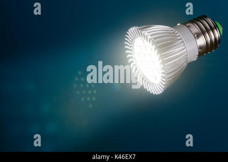 Energy saving  led light with flare and reflections in beam on a dark blue background Stock Photo