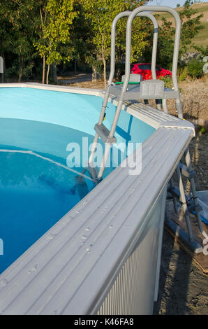 An above ground pool metal frame is being installed by worker Stock ...