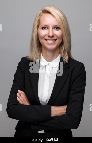Young and happy business woman in suit Stock Photo