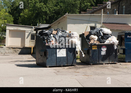Overflowing trash dumpsters. Stock Photo