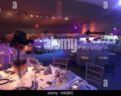 Ballroom set up ready for charity ball with an orange and black theme Stock Photo