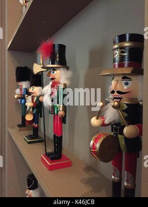 Four nutcracker dolls (toy soldiers) lined up on a shelf Stock Photo