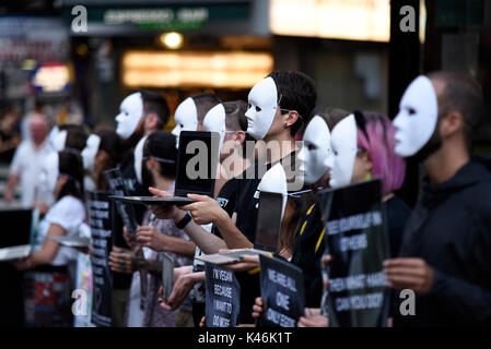 Earthlings Experience animal rights activists protesting outside Burger King in Leicester Square, London. Masks. Masked activists Stock Photo
