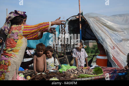 Lahore, Pakistan. 05th Sep, 2017. Gypsy family hang strips of salted meat collected from different places preserve for longer time to use during the Muslims Eid al-Adha or Festival of Sacrifice. Credit: Rana Sajid Hussain/Pacific Press/Alamy Live News Stock Photo