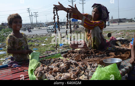 Lahore, Pakistan. 05th Sep, 2017. Gypsy family hang strips of salted meat collected from different places preserve for longer time to use during the Muslims Eid al-Adha or Festival of Sacrifice. Credit: Rana Sajid Hussain/Pacific Press/Alamy Live News Stock Photo