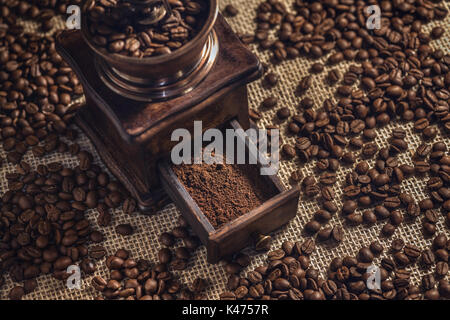 Roasted coffee beans in the coffee grinder. Stock Photo
