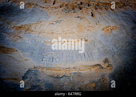 tourist carvings in sandstone rock Mt Moffatt National Park Stock Photo