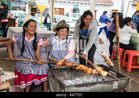 Gualaceo, Ecuador - Mar 13, 2016: Vendors prepare cuy (guinea pig) for lunch Stock Photo