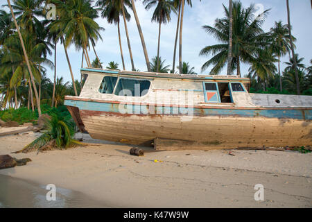 Old wooden boat on beach at Derawan Island, Kalimantan Stock Photo