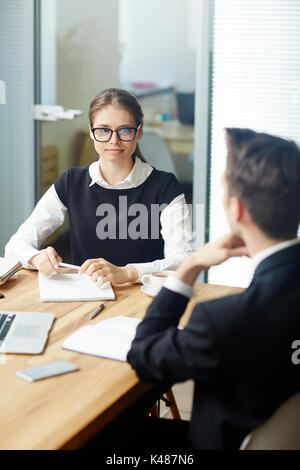 Business professionals discussing project details using a tablet during ...