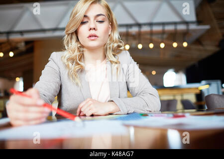 Pretty Designer Wrapped up in Work Stock Photo