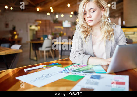 Pensive Fashion Designer Focused on Work Stock Photo