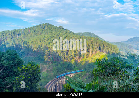 The passenger morning train runs along the Nine Arches Bridge, the main tourist attraction in town Ella, Sri Lanka Stock Photo