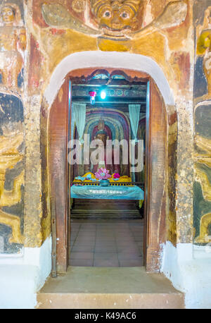 BATTALA, SRI LANKA - DECEMBER 2, 2016: The Dragons Arch above the door to the image house of Yudaganawa temple with the statue of Meditating Buddha in Stock Photo