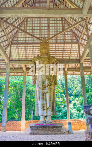 The ancient Dambegoda Bodhisattva statue is covered with roof located in jungle of Sri Lanka Stock Photo