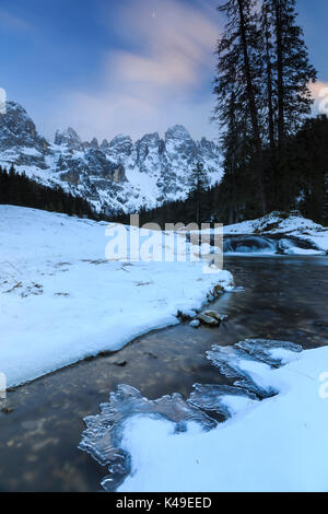 A frozen creek under a cold winter sky. Venagia Valley Panaveggio Natural Park Dolomites Trentino Alto Adige Italy Europe Stock Photo