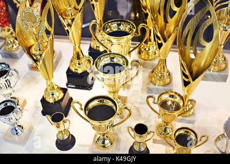 Award gold cups in the display case Stock Photo