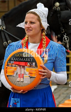 Dutch cheese girl with a Gouda cheese truckle, cheese market Gouda ...