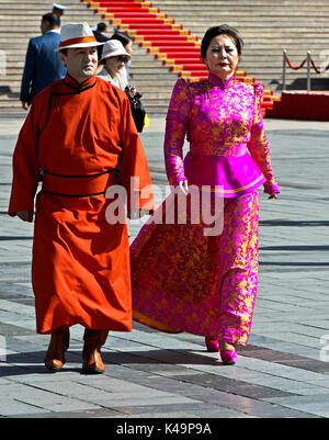 Local Man And Woman In Traditional Dress At The Local Man And Woman In Traditional Dress At The Mongolian National Costume Festivel And Parade, Sukhba Stock Photo
