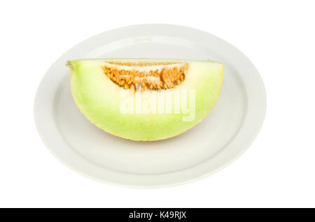 galia melon portion on a plate isolated against white Stock Photo