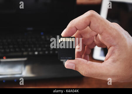 Close-up hand holding memory card, made in china technology product Stock Photo