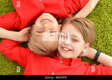 Smiling boys lying on floor Stock Photo