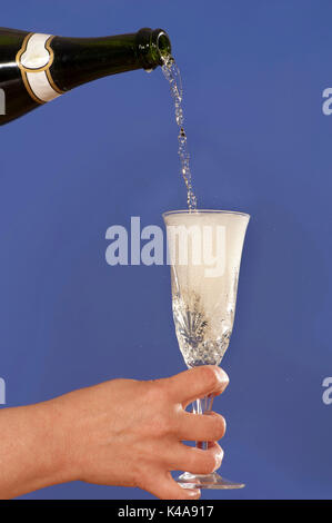 festive still life pouring champagne into glasses in flute christmas ornament