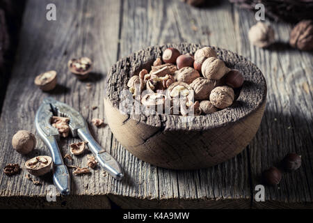 Healthy various nuts with with old nutcracker Stock Photo