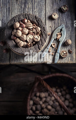 Tasty various nuts with with old nutcracker Stock Photo