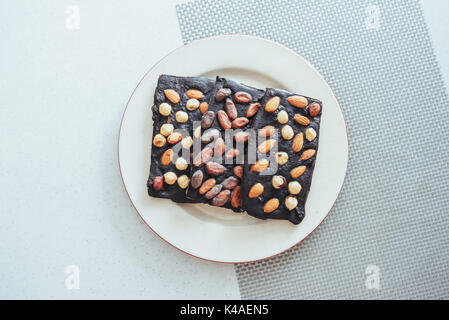 Dark chocolate, isolated on white with whole nuts Stock Photo