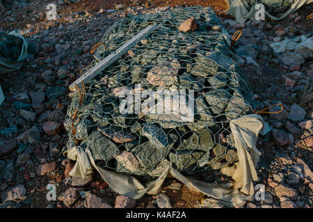 Granite stones in a metal grid Stock Photo