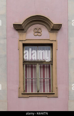 Elegant, decorated window with red and white striped blinds pulled down Stock Photo